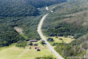 In this image, the race course winds through the verdant rolling hills before the Maitland River turnaround. Protected by the valley, riders get a welcome respite from the winds and the opportunity to enjoy some of the best views that you can get on an Ironman anywhere in the world.